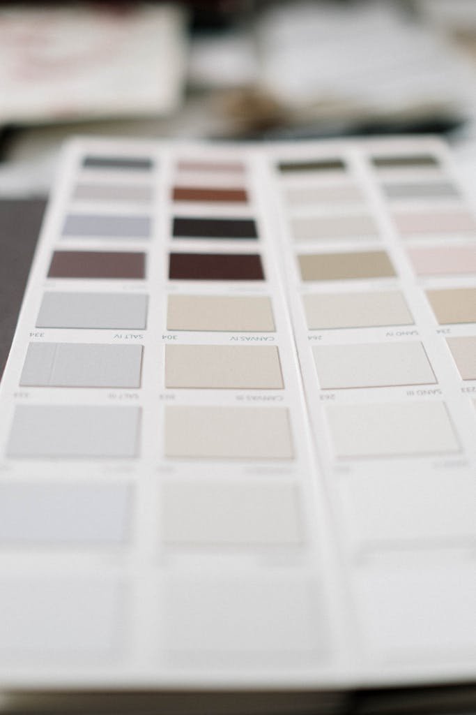 Close-up of a neutral color palette sample sheet showing soft tone swatches for white balance and color grading reference in photography